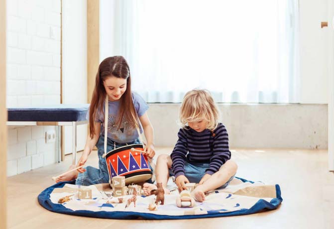 two baby playing on the ground