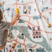 small baby playing on map