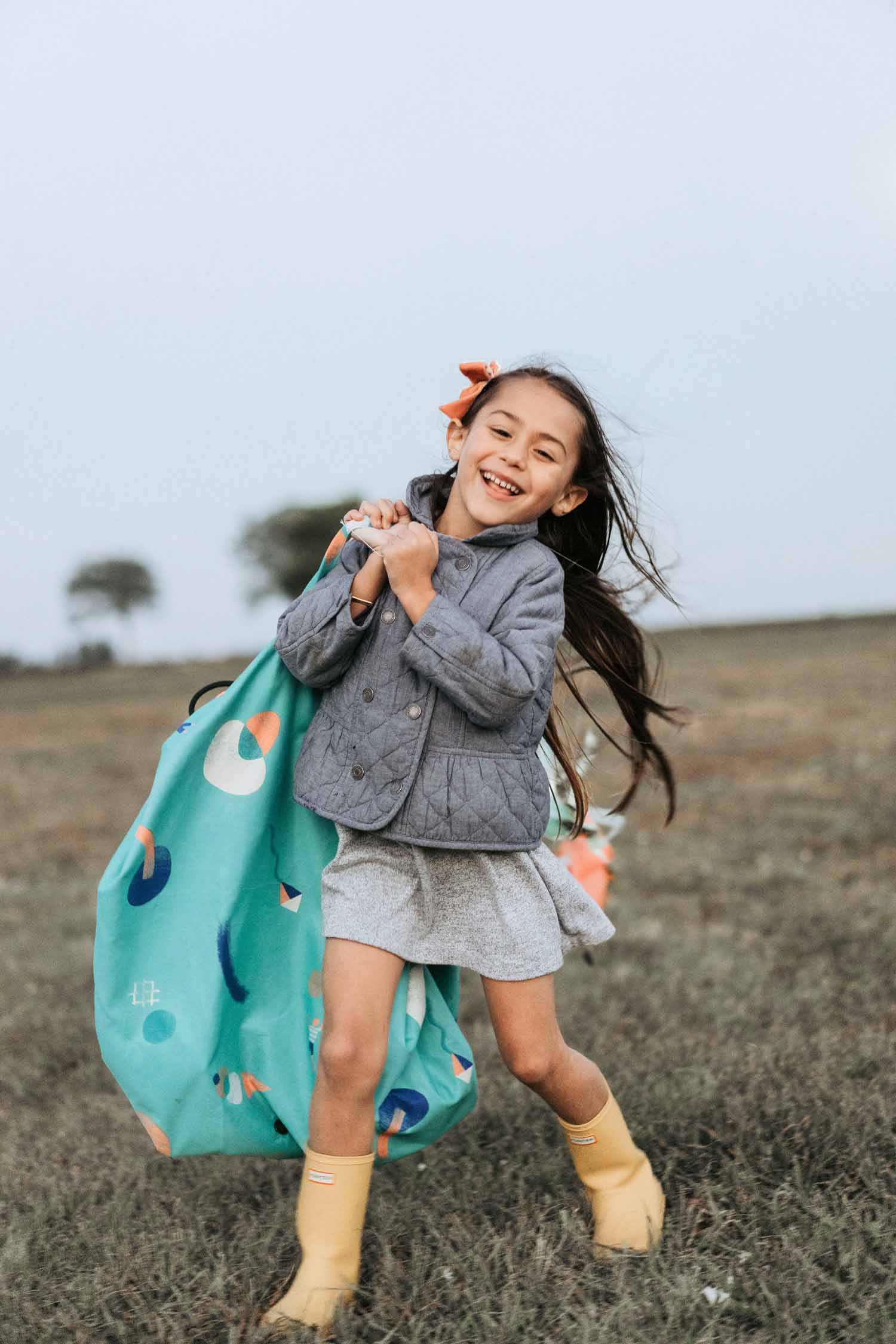 outdoor play toy storage bag, girl carrying the bag