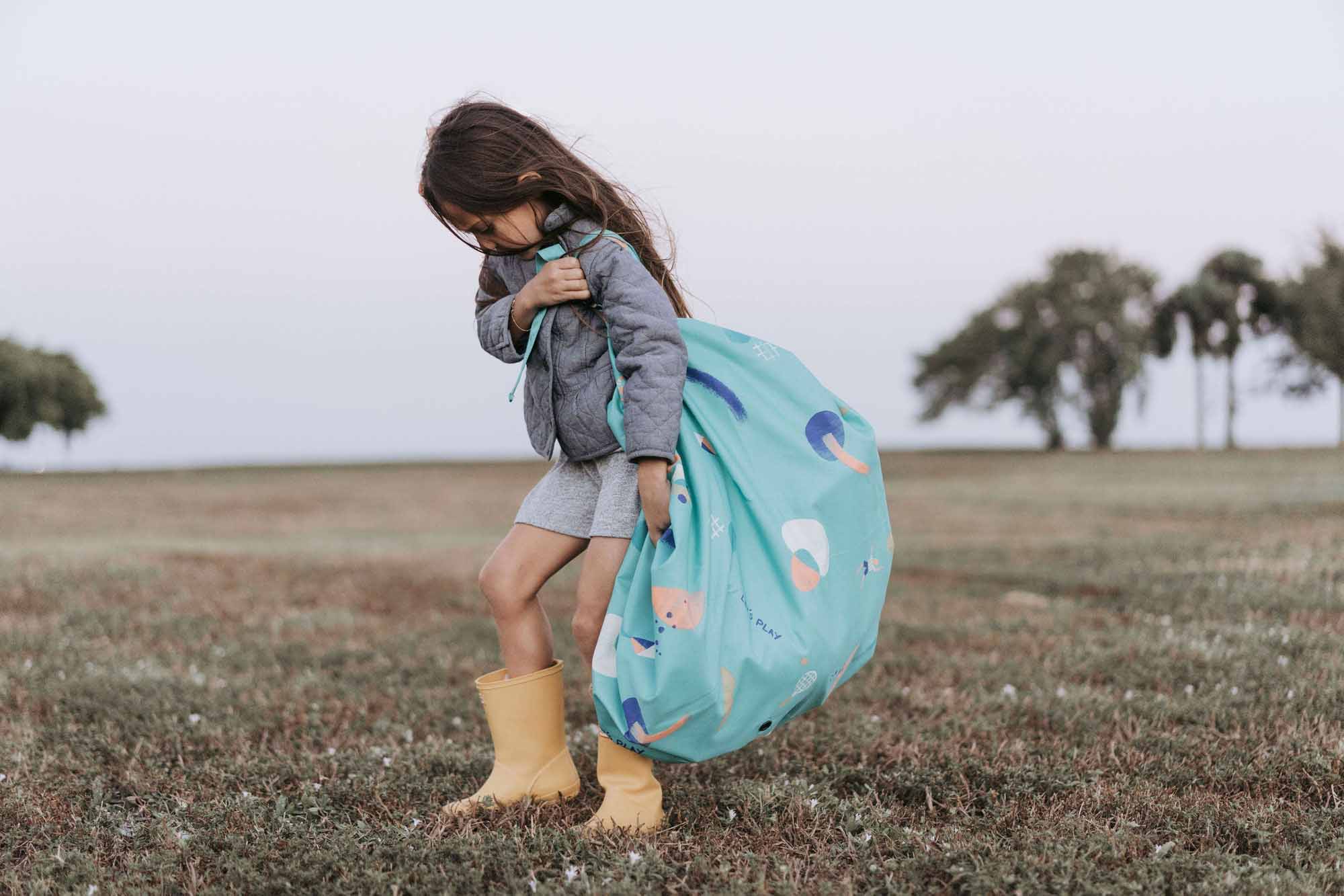 outdoor play toy storage bag, girl carrying the bag