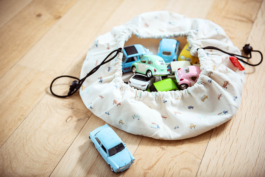 Mini cars toy storage bag, closed and filled with toys