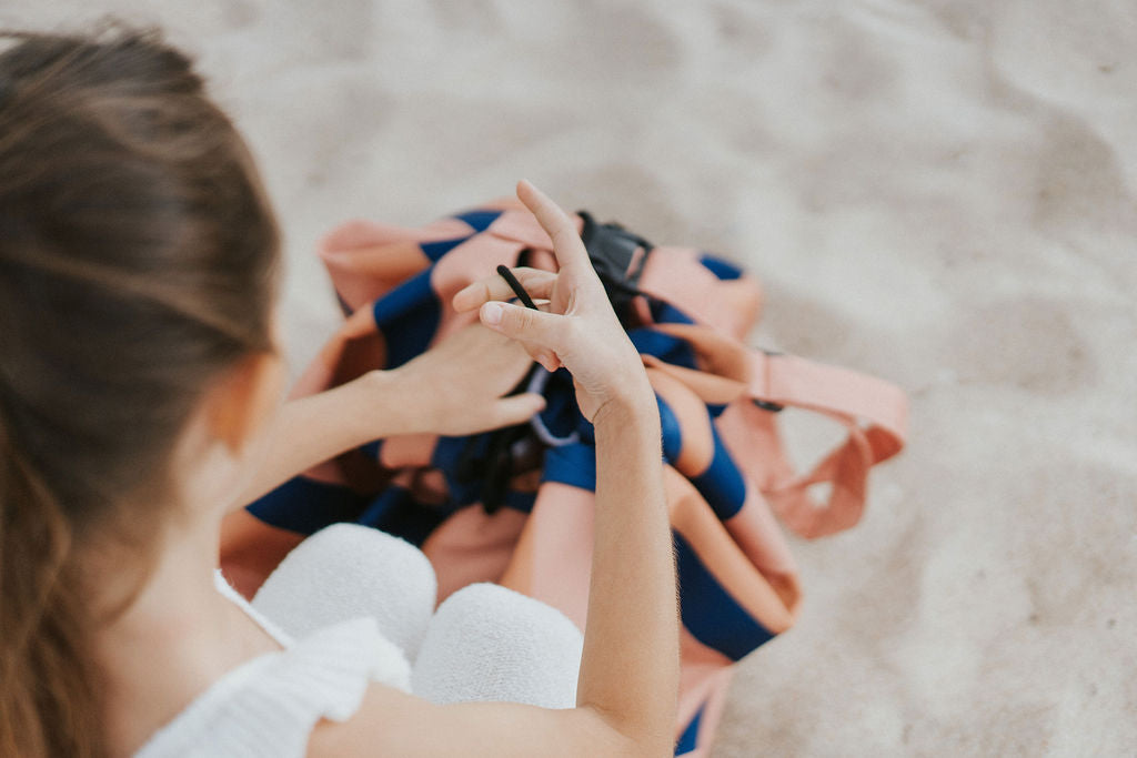 Play&Go outdoor storage bag and play mat, mokka stripes, girl playing with rope of the bag
