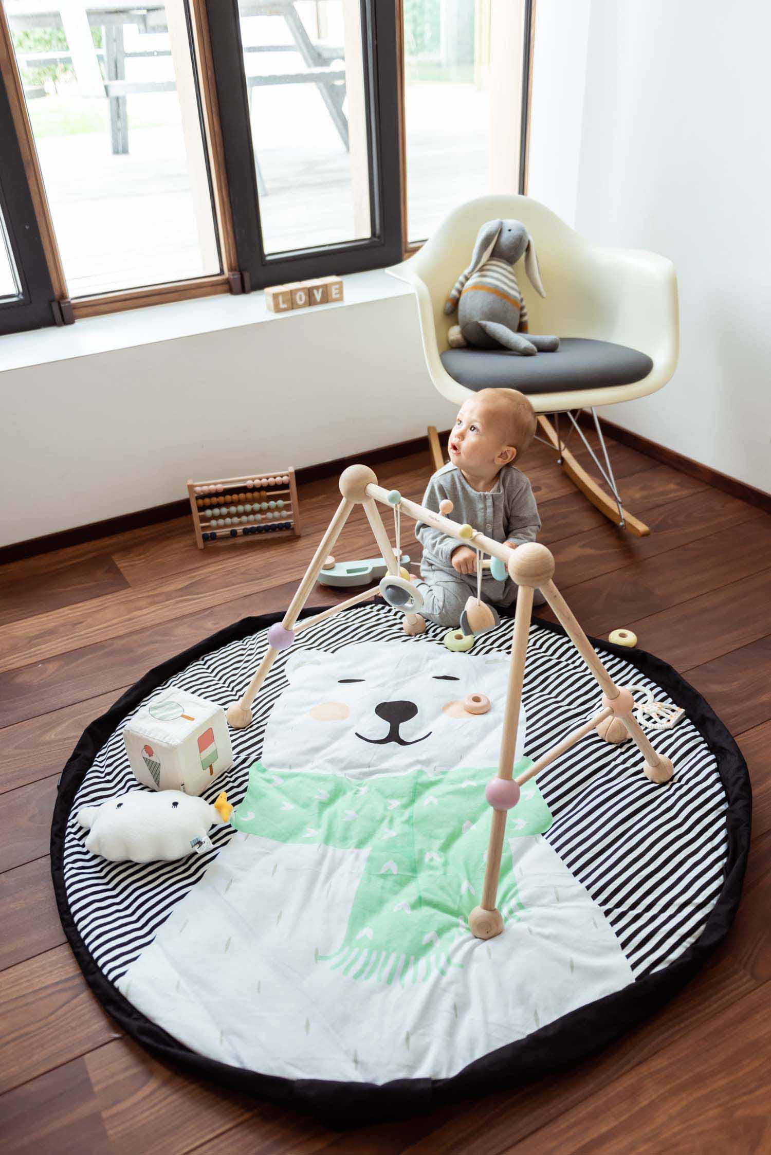 Play&Go storage bag and soft padded baby play mat, soft toys, print polar bear with scart, black and white stripes, playing baby, chair in corner
