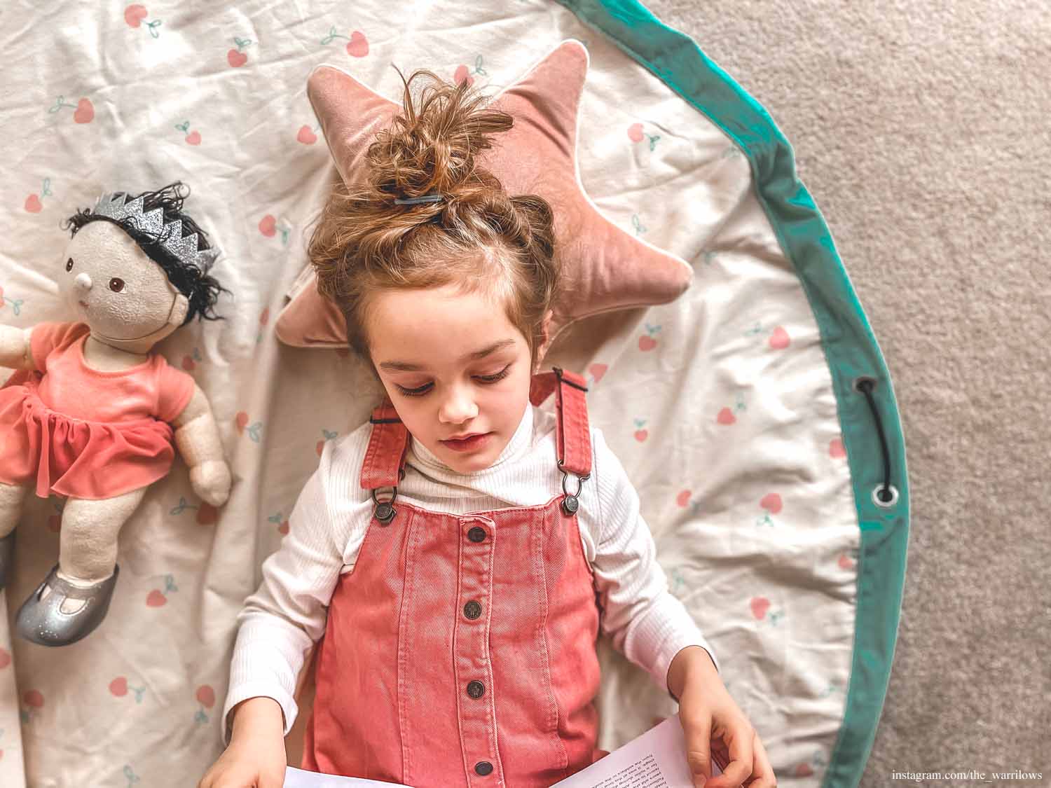 Play&Go storage bag and play mat, print cherry love, girl lying on mat, reading a book